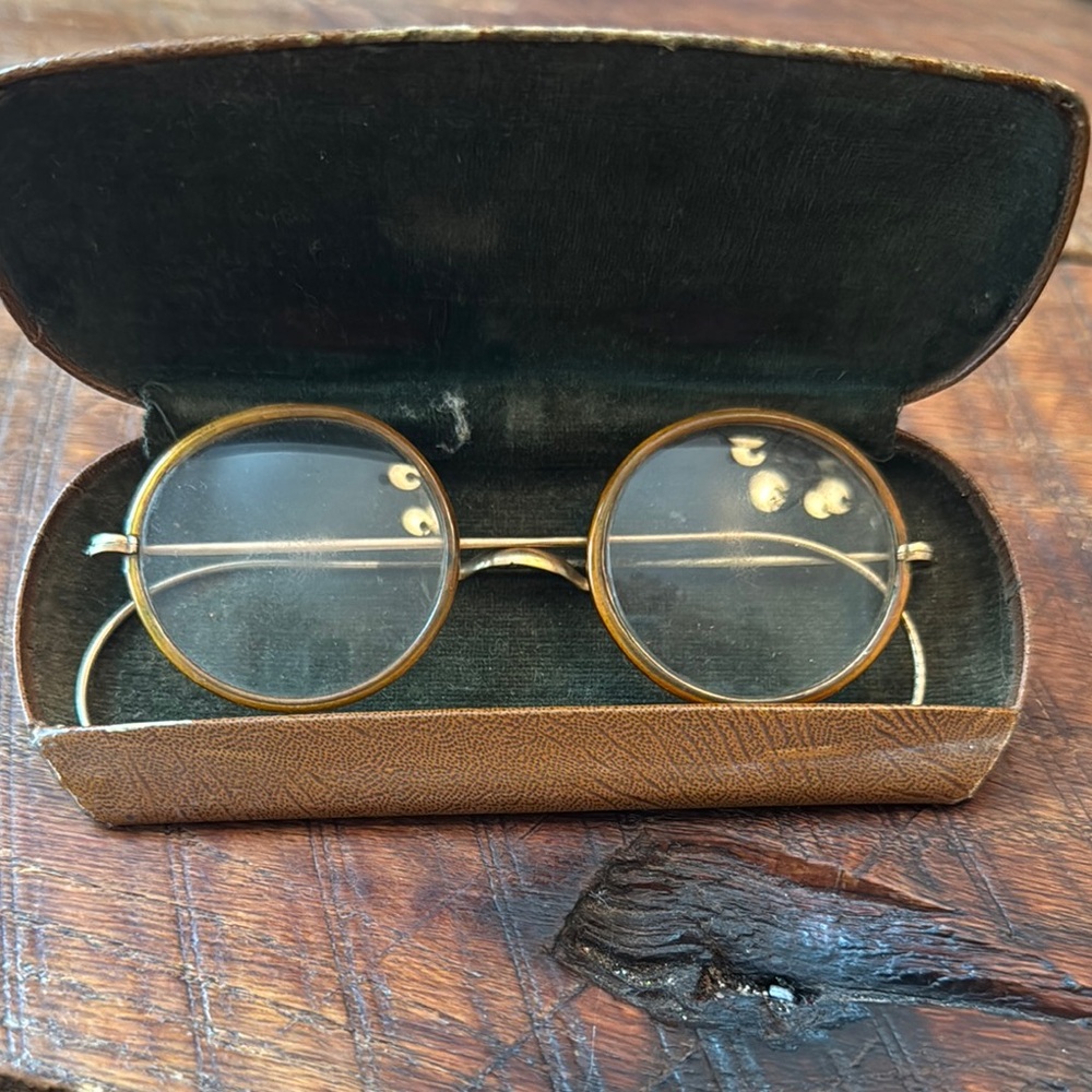 Antique gold and I believe tortoise shell glasses.